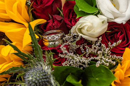 The Bride and Grooms Wedding Rings in the Bridal Bouquetの写真素材