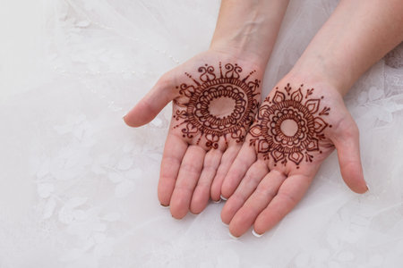 The bride had beautiful delicate artwork placed on the palms of her hand for her wedding day.の写真素材