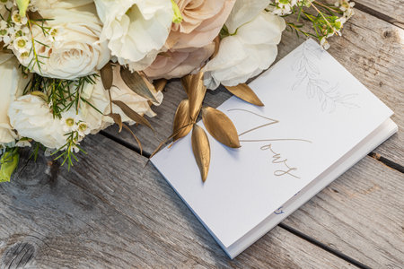 The Brides Wedding Vow Book Next To Bouquetの写真素材
