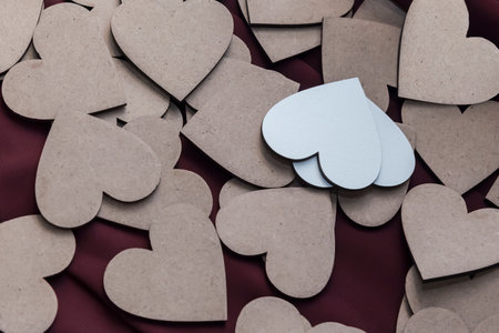 Cute little carved wooden white and brown textured love hearts that you can write messages on.の写真素材
