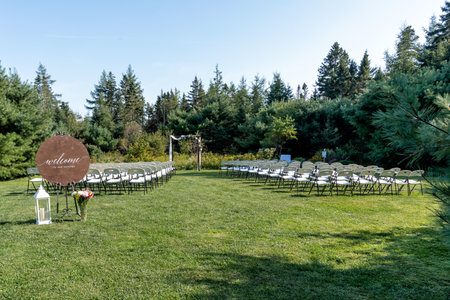 A wedding ceremony in a meadow surrounded by a forest.の写真素材