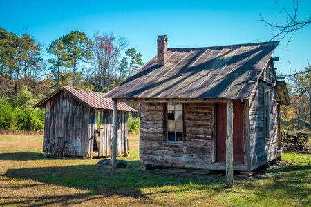A small abandoned homestead with a shed and bicycle next to it in the north Georgia mountains still...