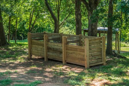 Three system compost bins together wooden with slats to add or take off for composting garden yard...