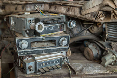 White, Georgia USA - March 28, 2018  Stack of old vintage car radios and tape deck dirty and broken thrown aside with other junk from a bygone eraのeditorial素材