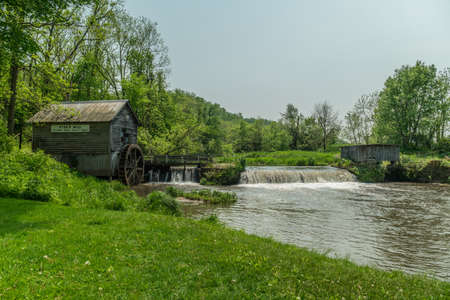 Ridgeway, Wisconsin USA - May 31, 2019  Historic Hyde's mill in rural Wisconsin one of the last mill to be powered by a wooden water wheel located on mill creek on a bright overcast day in late springのeditorial素材