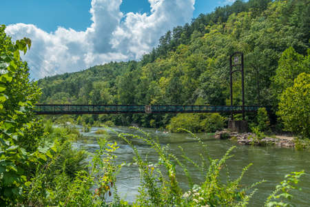 Copperhill, TN USA - September 03, 2016  Suspension bridge at the Ocoee whitewater center was the site for the 1996 Olympics run by the U.S. forest service that connects to the trailsのeditorial素材