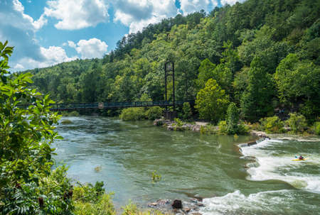 Copperhill, TN USA - September 03, 2016  U.S. forestry bridge across the Ocoee river at the whitewater center connecting the trails to the center with kayaking, rafting and hiking recreationのeditorial素材