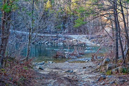 Entrance for vehicles to cross through the rocky creek with flowing water over to the exit going to...