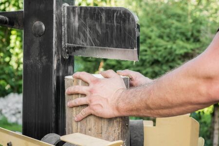 Firewood split with wooden splitterの写真素材