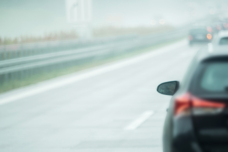 A car is driving on the road in the rainの写真素材