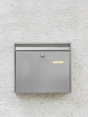 A silver mailbox on the wallの写真素材