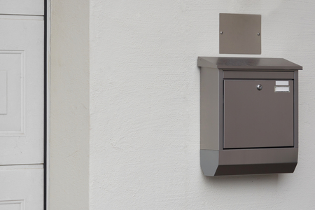 A silver mailbox on the wallの写真素材