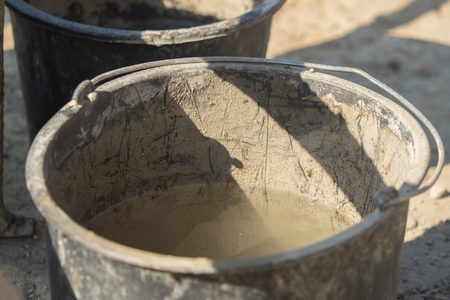 Construction site work with concrete mixer and wheelbarrowsの写真素材