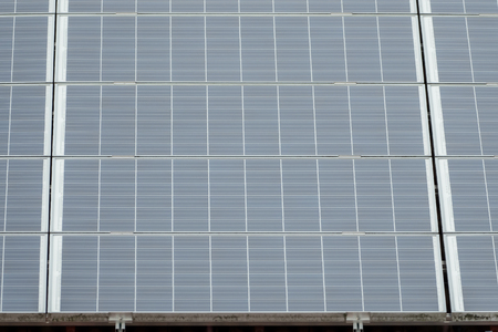 A solar system on a roof, sky in the background