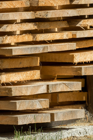 Stacked wooden boards are waiting for processingの写真素材