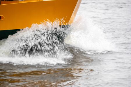 A boat in full speed over the waterの写真素材