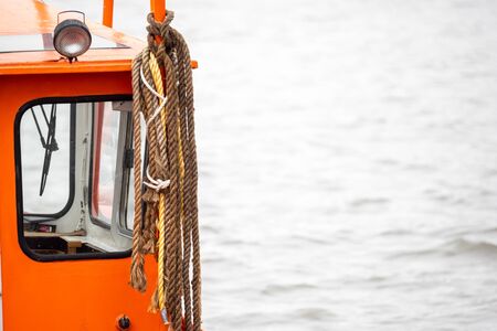 Close-up, ropes hang on a boat cabinの写真素材