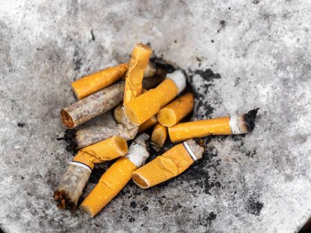 Squeezed remnants of cigarettes in an ashtrayの写真素材