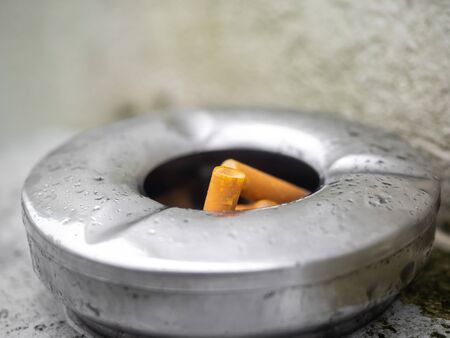 Squeezed remnants of cigarettes in an ashtrayの写真素材