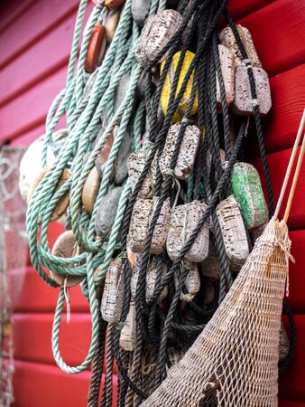 Fishing nets and ropes hang outside on the house wallの写真素材
