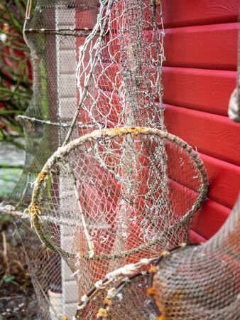 Fishing nets and ropes hang outside on the house wallの写真素材