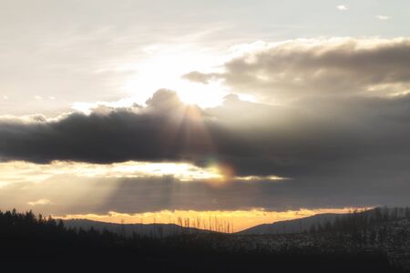 Beautiful romantic sunset in the mountains, black silhouetteの写真素材