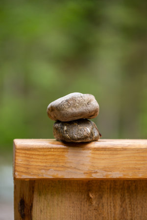 Two stones on top of each other on a wooden bridgeの写真素材