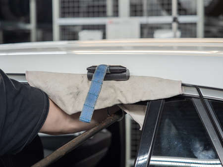 Repairing dents in a carの写真素材