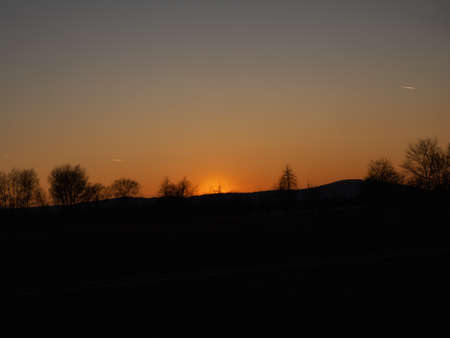 Beautiful romantic sunset in the mountains, black silhouetteの写真素材