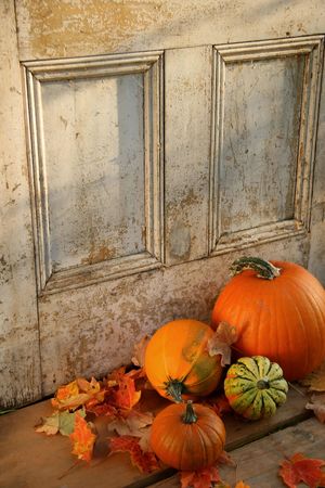Pumpkins, broom and gourds at the door ready for halloweenの写真素材