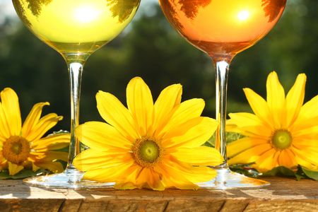 Golden wine in the sun on rustic tableの写真素材