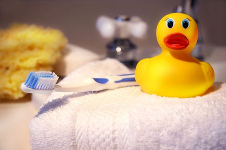 Rubber duck, toothbrush and sponge ready for bathtimeの写真素材