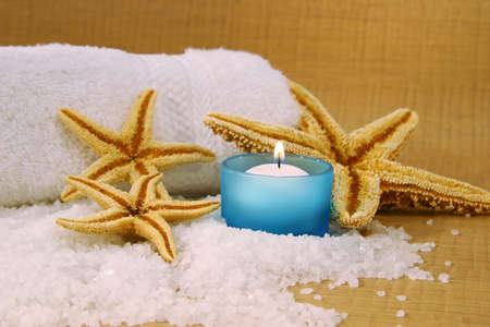 Blue spa candle with sea salt and starfishの写真素材