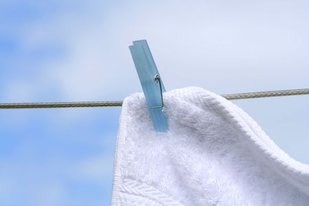 Wash day/ Fluffy towel hanging with clothespin on the lineの写真素材
