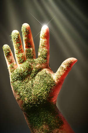 Open hand with green substance against dark backgroundの写真素材
