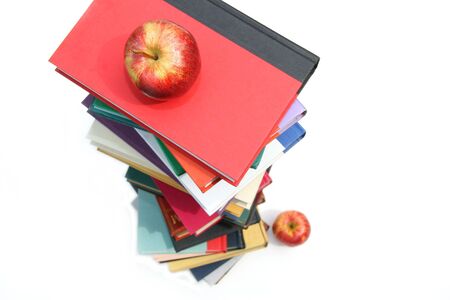 Large piles of books with apples on white backgroundの写真素材