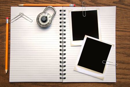White copy book, pencils and polaroids on oak surfaceの写真素材