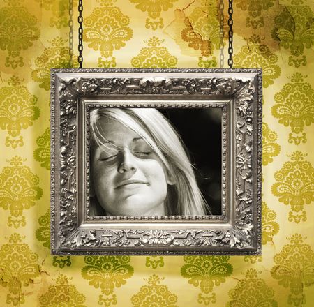 Picture frame hung against floral wallpaper background/yellowの写真素材