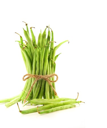 Unwashed green beans tied with cord on white background