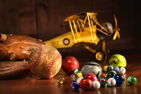 Old baseball and glove with antique toys on wood floorの写真素材