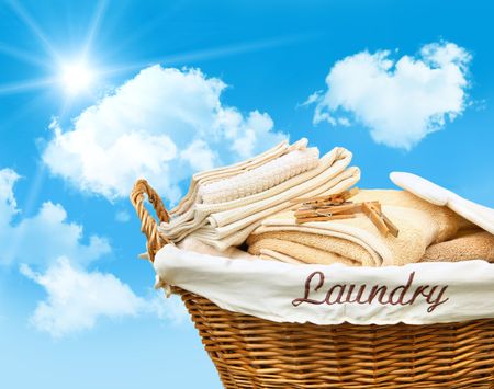 Laundry basket with towels against a blue skyの写真素材