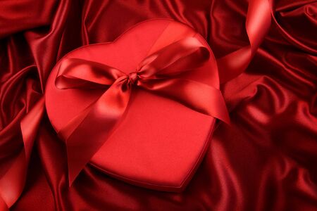 Box of chocolate on red satin backgroundの写真素材