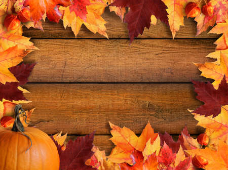 Autumn leaves frame with wood backgroundの写真素材