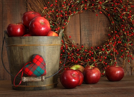 Red apples in wood bucket for holiday bakingの写真素材