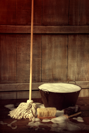 Cleaning mop and bucket with wet soapy floorの写真素材