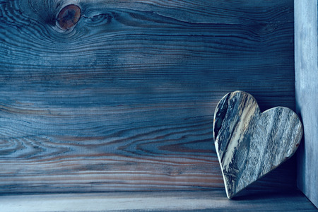 Wooden heart on shelf with wood backgroundの写真素材
