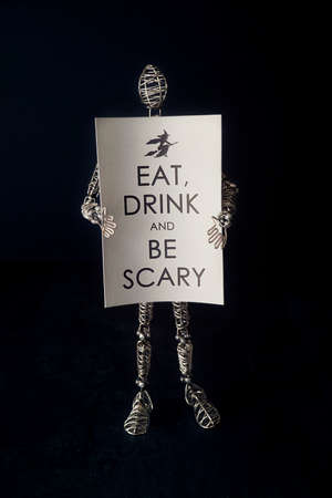 Wire mannequin holding festive halloween cardの写真素材