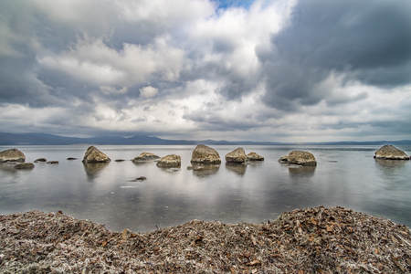 Italy, Anguillara Sabazia - 31 January 2016: Panoramic photos in Bracciano Lake on a cloudy winter morningの写真素材