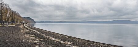 Italy, Bracciano, Anguillara Sabazia - 31 January 2016: It is a very cloudy morning but not very cold. This is the classic winter day on Bracciano Lake and Anguillara still sleeps in the backgroundの写真素材