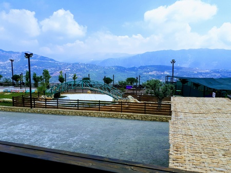 A view from Mount Lebanon consisting of multiple mountains that are filled with trees and greenery.の写真素材